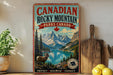 A vintage-style sign for Canadian Rocky Mountain Parks Canada, featuring a mountain landscape with a bighorn sheep, a lake, and pine trees.