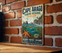 A vintage-style metal sign for Cape Arago Marine Reserve, Oregon, featuring a coastal landscape with a lighthouse, ocean, and marine life.