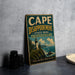 A vintage-style sign for Cape Disappointment State Park in Washington, featuring a lighthouse and a coastal landscape.