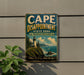 A vintage metal sign for Cape Disappointment State Park in Washington, featuring a lighthouse and a coastal landscape.