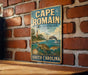A vintage metal sign for Cape Romain, a marine protected area in South Carolina, featuring a lighthouse, turtle, and fish.