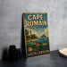 A vintage metal sign for Cape Romain, a marine protected area in South Carolina, featuring illustrations of a lighthouse, a dolphin, and various marine life.
