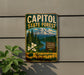 A vintage-style metal sign for Capitol State Forest in Washington, featuring a mountain landscape with pine trees and white flowers.