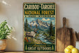 A vintage-style metal sign advertising the Caribbean Targhee National Forest in Idaho, Wyoming, featuring a deer in a mountainous landscape.