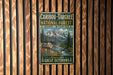 A vintage metal sign advertising the Caribbean-Targhee National Forest in Idaho, Wyoming, featuring a deer and a mountain landscape.