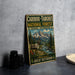 A vintage-style metal sign advertising the Caribbean-Targhee National Forest in Idaho, Wyoming, featuring a deer and mountain landscape.