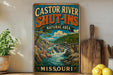 A vintage-style sign for the "Castor River Shut-ins Natural Area" in Missouri, featuring a scenic illustration of a waterfall and forest.