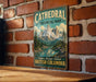 A vintage-style metal sign for Cathedral Provincial Park in British Columbia, featuring a scenic mountain landscape.