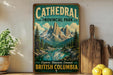 A vintage-style sign for Cathedral Provincial Park in British Columbia, featuring a scenic mountain landscape with a lake and pine trees.