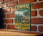 A vintage metal sign for Cathedral State Park in West Virginia, featuring a scenic illustration of the park's rock formations and landscape.