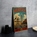 A vintage metal sign with the text "MODENA Italia" and "Cattedralle - Torre civica - Piazza Grande" is displayed on a table, with a stack of black camera lenses and a white plate nearby.