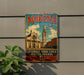 A vintage metal sign with the text "MODENA Italia" and an illustration of a church and buildings, mounted on a wall.