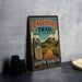 A vintage trail sign for the Centennial Trail in South Dakota, featuring a scenic mountain landscape and a dirt path leading to the trail.