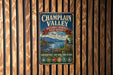 A vintage metal sign for the National Heritage Partnership in New York, featuring a scenic landscape with mountains, a river, and a castle.
