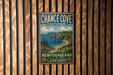 A vintage metal sign for Chance Cove Provincial Park, New Brunswick, Labrador, hanging on a wooden wall.