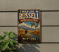 A vintage metal sign for Charles M. Russell's National Wildlife Refuge in Montana, featuring an illustration of a deer and ducks in a scenic landscape.