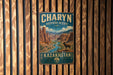 A vintage metal sign for Charyn Biosphere Reserve, featuring a mountain landscape with a river and a bighorn sheep.
