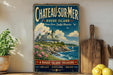 A vintage-style sign for Chateau Surmer, a Rhode Island landmark, featuring a picturesque illustration of the chateau on a cliff overlooking the ocean.