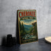 A vintage metal sign for the National Forest in Tennessee, featuring a scenic mountain landscape with a river and pine trees.