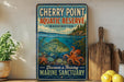 A vintage-style sign for Cherry Point Aquatic Reserve in Washington, featuring an illustration of a fish and an octopus, along with the text "Discover a Thriving Marine Sanctuary".