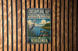 A vintage-style metal sign for Chesapeake Bay National Estuarine Research Reserve, featuring a heron and ducks in a serene landscape.