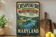 A vintage-style sign for Chesapeake Bay Watershed, featuring a scenic illustration of the bay and surrounding landscape, with the text "Chesapeake Bay Watershed Cultural Landscape Maryland" prominently displayed.