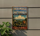 A vintage metal sign on a wall, featuring a cannon and a landscape with mountains, indicating that it is a sign for Chickamauga and Chattanooga National Military Park in Georgia.