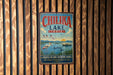 A vintage metal sign for Chilika Lake in India, featuring a seagull, a boat, and a scenic landscape.