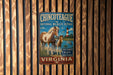 A vintage metal sign for the Chincoteague National Wildlife Refuge in Virginia, featuring a horse and a bird in a scenic landscape.