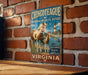 a vintage metal sign with a horse and a bird, mounted on a brick wall.