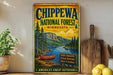 A vintage-style metal sign for Chippewa National Forest in Minnesota, featuring a scenic landscape with a lake, mountains, and a canoe.
