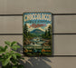 A vintage-style metal sign for Choccolocco State Forest in Alabama, featuring a scenic mountain landscape with a river and pine trees.