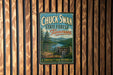 A vintage-style metal sign for Chuck Swan State Forest in Tennessee, featuring a scenic landscape with pine trees and a lake.