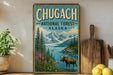 A vintage-style sign for Chugach National Forest in Alaska, featuring a moose in a forest setting with mountains in the background.