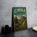 A vintage-style metal sign for Cibola National Forest in New Mexico, featuring a scenic landscape with mountains and pine trees.