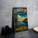 A vintage-style metal sign for Clearwater Lake Provincial Park in Manitoba, Canada, featuring a scenic landscape with pine trees, a lake, and mountains.
