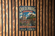 A vintage metal sign with the text "Quedlinburg, Germany" and "College Church, Castle and Old Town" is displayed on a wooden wall.
