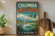 A vintage-style sign for Columbia Wetlands, a wildlife sanctuary in Canada, featuring a serene landscape with a heron, ducks, and mountains in the background.
