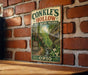 A vintage-style metal sign for Conkles Hollow State Nature Preserve in Ohio, featuring a scenic image of a forest and a stream.