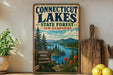 A vintage-style metal sign for Connecticut Lakes, New Hampshire, featuring a scenic landscape with pine trees, mountains, and a lake.