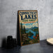 A vintage metal sign for Connecticut Lakes State Forest in New Hampshire, featuring a scenic illustration of the lake surrounded by pine trees and mountains.