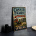 A vintage-style metal sign for the Conner Prairie Living History Museum in Indiana, featuring an illustration of a horse-drawn carriage and a barn.