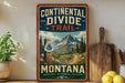A vintage-style sign for the Continental Divide Trail in Montana, featuring a mountain landscape and a trail marker.