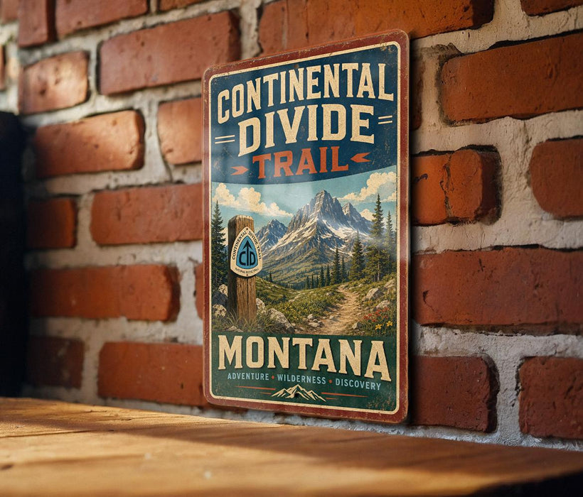 A vintage-style metal sign with the text "Continental Divide Trail Montana" is displayed on a brick wall.