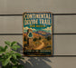 A vintage metal sign for the Continental Divide Trail in New Mexico, featuring a scenic mountain landscape and a trail marker.