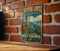 A vintage-style metal sign for the Cooper's Rock State Forest in West Virginia, featuring a scenic mountain landscape with a river and pine trees.