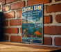 A vintage-style metal sign for the Cordell Bank National Marine Sanctuary in California, featuring illustrations of marine life and the text "Cordell Bank" and "National Marine Sanctuary California".