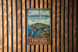 a vintage-style metal sign with a coastal landscape and a bird, mounted on a wooden wall.