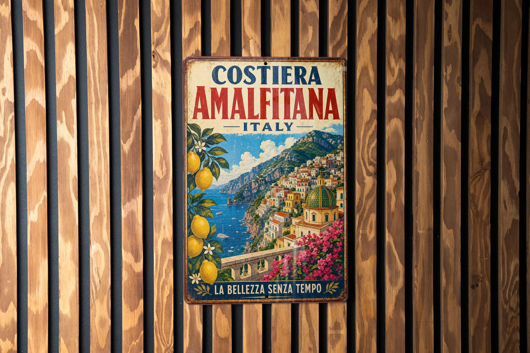 A vintage metal sign with a colorful illustration of a coastal town in Italy, featuring buildings, flowers, and a body of water.