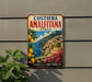 A vintage-style metal sign with a colorful illustration of a coastal town in Italy, featuring buildings, flowers, and a body of water.